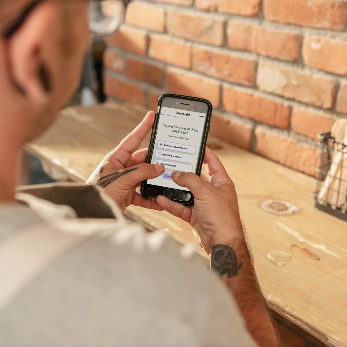 Man looking at 9amHealth treatment plan on his phone